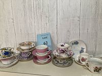 Overview of all teacups and saucers arranged in groups by pattern and color.