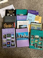 All collectible books laid out on carpet, showing titles focused on the Finger Lakes region and other notable works.