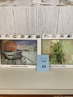 Photo of two glass cutting boards packaged in original boxes with a winter scene and botanical corn artwork visible.