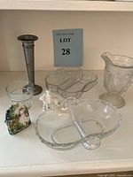 Photo showing the full vintage glassware collection including the divided oval relish dish, ornate pitcher, small glass cup, metal candlestick, decorative figurine, and metal flower holder