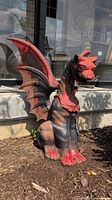 Front view of painted cast iron dragon statue outdoors showing overall appearance and size