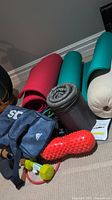 Overview of the fitness items including gym bag, yoga mats, resistance bands, weights, and roller.