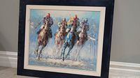 Framed painting of four racing thoroughbreds and jockeys, full front view showing frame and artwork.