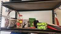 Wide view of a shelf showing assorted golf balls, tees, books, and umbrella