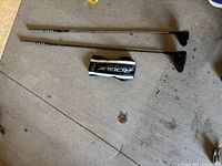 Two Callaway Rogue clubs (driver and 4 wood) and headcover on concrete floor