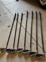 Eight left-handed TaylorMade M2 irons laid out side by side