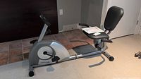 Side view of the Stamina 1350 magnetic recumbent exercise bike showing the seat, backrest, pedals, and console area.
