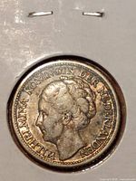 Obverse of 1944 Curacao 1/4 Gulden silver coin showing Queen Wilhelmina facing left with surrounding text.