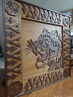 Front view of the square wooden framed raised woodcut Bengal tiger art with geometric border pattern.