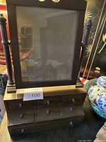 Front angle view of antique desktop valet showing frame and top row of drawers