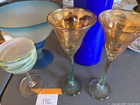 Blue frosted bowl with two amber glasses and small signed glass on display with cobalt vase.