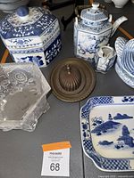 Top view of the blue and white hexagonal Japanese teapot, creamer, frosted Verlys bowl, duck serving bowl, and rectangular blue and white tray on table