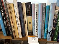 Books on a shelf showing titles and spines of 17 hardcover books focused on art, design, and decorating.