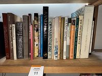 Books arranged on a bookshelf showing titles mostly on home decor and interior design