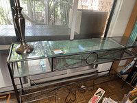 Metal framed glass table with copper insert, showing length and depth; glass top broken in two spots
