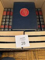 Top view of a set of blue hardcover Nobel Prize books with decorative gold spines and embossed gold medallions on front covers.