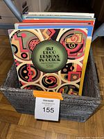 Photo of a boxed collection of books showing 'Art Deco Designs in Color' as the top book in the lot.