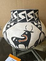 Front view showing overall jar shape, geometric and deer designs