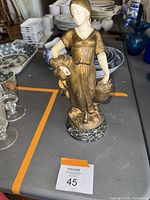 Full front view of bronze figure on table