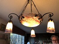 Overall view of chandelier showing central bowl and three pendant shades