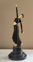 Overall front view of the dancer figurine and base against neutral background