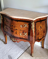 Front view showing two drawers with marquetry panels and ormolu handles