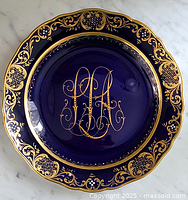 Full top view of the Meissen plate showing cobalt blue color with gold ornate border and central monogram decoration