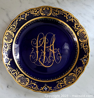 Full view of the cobalt blue Meissen plate with gold scroll and lattice border, showing the entire ornate design.