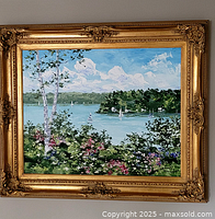 Full frontal view of the oil painting in its ornate gold frame showing the complete lakeside scene.
