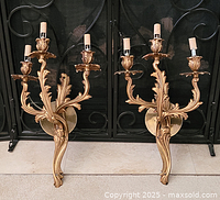 Front view of both sconces against fireplace grate