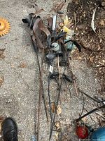 Several metal garden decor stakes including solar lights, bird and flower designs, some rusted and worn.