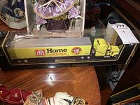 Diecast Home Hardware 50th Anniversary tractor trailer displayed in original black base box with clear plastic cover.