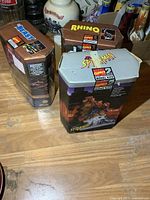 Three Marvel Comics model kits boxed: Spider-Man, Rhino, Beast, on wooden surface.