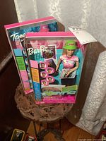 Two boxed 2 N Sync Barbie dolls including Teresa and Barbie displayed on a wooden surface.