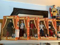 Photo showing all five N Sync band member marionette dolls in their original packaging displayed on a shelf.