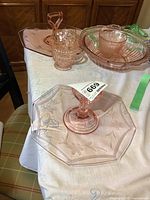 Photo showing one of the octagonal, handled serving dishes with floral design, creamers and large bowl in the background
