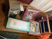 Overview of all 5 dolls on a wooden bench including boxed and bagged dolls showing style and packaging condition