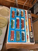 Original box showing all train cars and engine in plastic window; colorful artwork and labels for Life-Like Cannonball set