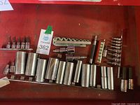 Multiple assorted sockets of various sizes, hex and star bit sockets, all mounted on metal strips for organization. Includes different sizes and types of sockets and bits.