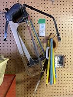 Photo showing two hacksaws mounted on pegboard with a bundle of assorted saw blades