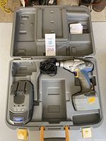 Full view of the Mastercraft Maximum cordless impact gun kit including gray carrying case, cordless impact gun with battery, and charger with power cord.