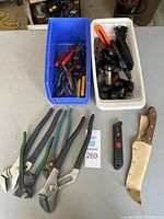 Overview of entire lot showing bins of tools, wrenches, pliers, knives, utility blades