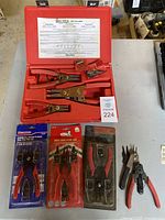 Overview photo showing all snap ring plier sets on table with cases and packaging