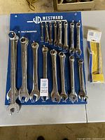 Full view of Westward combination wrenches on blue board with basin wrench in packaging
