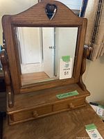 Front view of vintage wooden dressing mirror showing heart-shaped cutout and single drawer below mirror.