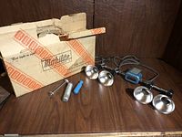 Vintage Mobihite light bar with accessories and original box on wooden surface