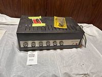 Front angle view of the vintage Realistic PA Amplifier PA-45 with accessories taped on top.