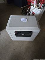 Beige Sentry Safe model 1170 with black lock mechanism, front angled view showing condition and overall size.