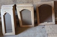Stack of eight small oak cupboard doors with arched openings