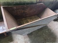 Top view of tapered steel cart showing overall form and interior